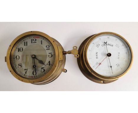 AN INTERESTING BRASS BULKEAD WALL MOUNTED CLOCKthe case in the style of the Kreigsmarine clock, the hinge stamped 92, the pla
