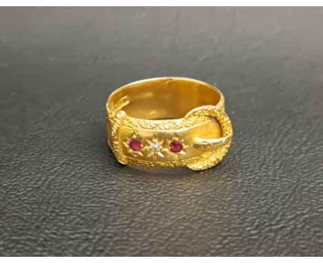 EDWARDIAN DIAMOND AND RUBY SET EIGHTEEN CARAT GOLD BUCKLE RINGthe ring set with two rubies flanking a small diamond, ring siz