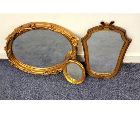 THREE GILT FRAMED VINTAGE WALL MIRRORSThe largest framed with swags and flora, 60 x 46cm (3)