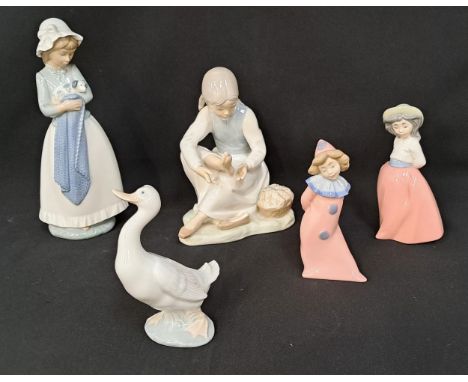 FIVE NAO FIGURES, including Girl resting foot, 21cm high; girl holding puppy, 26cm high; pink girl clown, 15cm high; girl in 