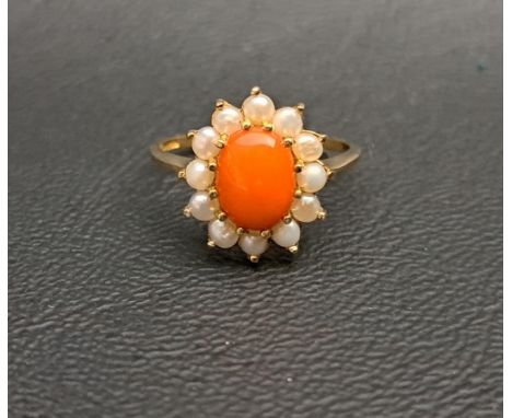 CORAL AND SEED PEARL CLUSTER RINGthe central oval coral cabochon in twelve seed pearl surround, on nine carat gold shank, rin