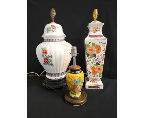 SELECTION OF THREE EAST ASIAN STYLE CERAMIC LAMPScomprising one with floral motifs on white ground, 32cm high; another depict