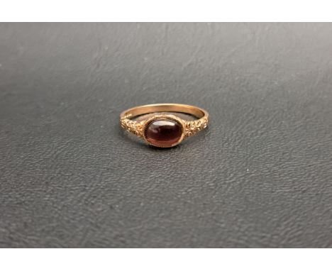 CABOCHON GARNET SINGLE STONE RINGon nine carat rose gold shank with decorative scroll decorated shoulders, ring size N-O