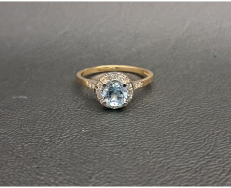 BLUE TOPAZ AND DIAMOND CLUSTER RINGthe central round brilliant cut blue topaz approximately 0.75cts in sixteen diamond surrou