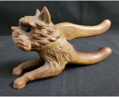 VINTAGE CARVED WOODEN NUTCRACKERin the form of a terrier dog, the top handle marked 'GRINDELWALD', 19.7cm long