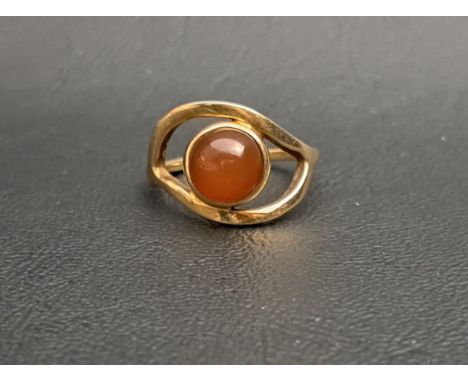 UNUSUAL OLA GORIE CABOCHON CARNELIAN SET RINGin shaped and pierced setting and on nine carat gold shank, ring size P and appr