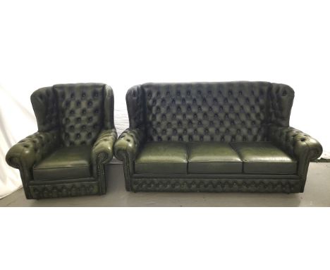 GREEN LEATHER CHESTEFIELD STYLE THREE SEAT WING BACK SOFA AND ARMCHAIRboth with button back and arms and stud detail, the sof
