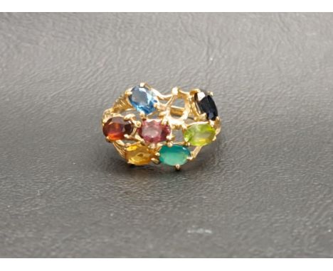 MULTI GEM STONE RINGon nine carat gold shank with pierced setting and textured detail, the gemstones including sapphire, garn