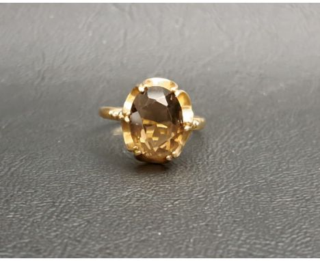 SMOKY QUARTZ SINGLE STONE RINGthe oval cut quartz measuring approximately 11.9mm x 8.9mm x 5.8mm, on nine carat gold shank, r
