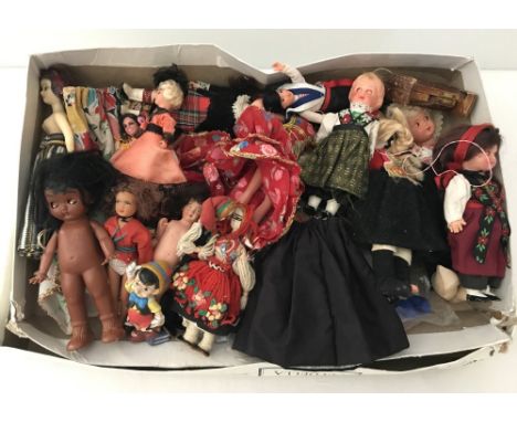 A box of vintage dolls many wearing National Costumes.  