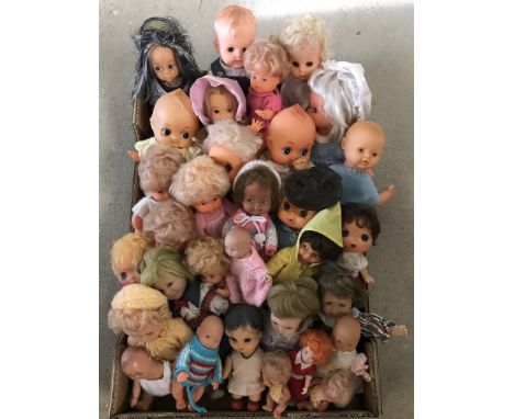 A box of vintage small vinyl dolls to include kewpie.  