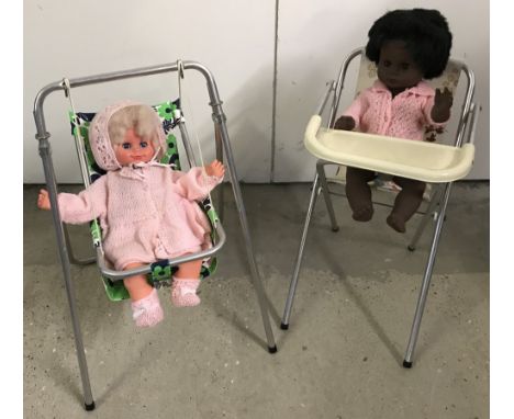 A vintage metal framed dolls high chair and swing chair. Together with 2 vintage vinyl dolls.  