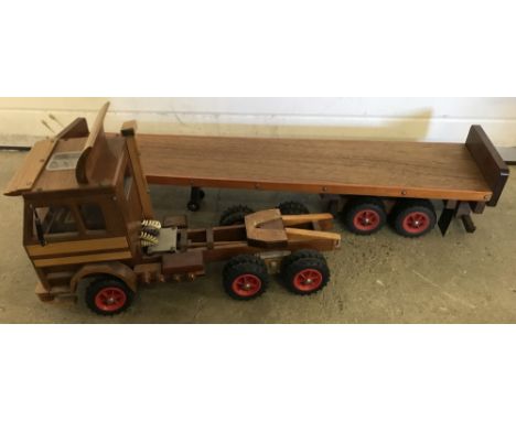 A large scratch built wooden Scania 142e Truck with flatbed trailer. Built in 1984, cab tilts to reveal engine. Total length 