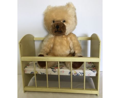 A 1950's Blonde Schuco nursery bear together with a vintage wooden toy dolls cot.  Total height of bear 53cm/21 inches approx