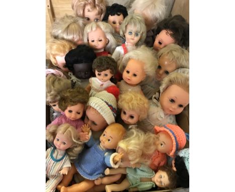 A box of mixed vintage vinyl dolls.  