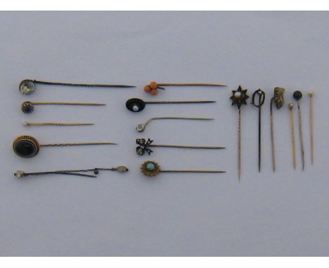 A mixed lot comprising sixteen untested stick / tie pins, including untested pearls, coral, agate etc.
