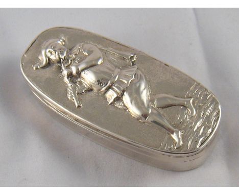 A George IV oval silver table snuff box, the lid with embossed figure of a jester playing a pipe. W.E, London, 1821. 4.5x10cm