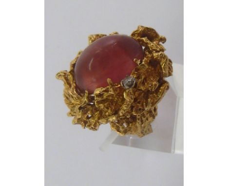 A yellow metal (tests 18 carat gold) naturalistic cabochon pink tourmaline and diamond ring, ruby approx 18 x 13mm, ring size