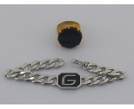 A mixed lot comprising a silver gilt onyx ring and a silver, enamel and diamond bracelet.

