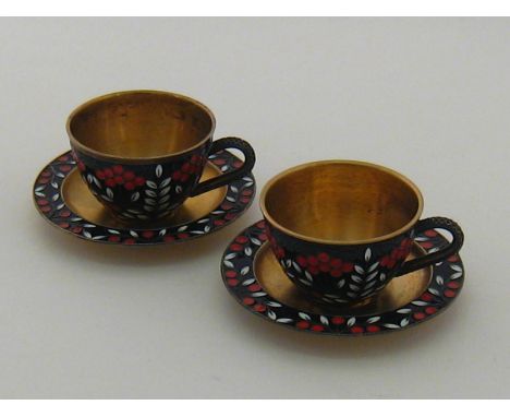A pair of Soviet Russian silver gilt cups and saucers with cloisonne enamel decoration. Moscow 916 assay . wt. 378gm. 