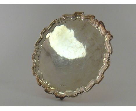 A silver salver on three scroll feet with chippendale rim by Alexander Clark & Co., Sheffield, 1957. 36.5cm. across, wt. 1202