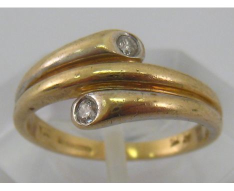 A yellow metal (tests 9 carat gold) two stone diamond ring, size K ½, 2.5 gms.