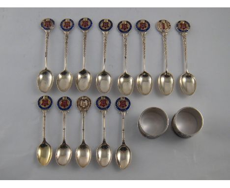 A pair of silver napkin rings, Birmingham 1936/7, eight plated teaspoons and five plated coffee spoons, all with the enamel c