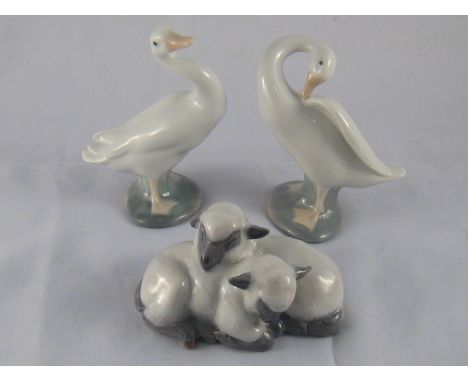 A Royal Copenhagen pair of little lambs resting closely, ref. 2769, together with a Lladro pair of geese. 