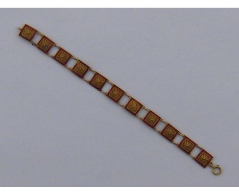 A yellow metal (tests 18 carat gold) red enamel bracelet, unascribed marks, approx 18cm long, 9 gms.
