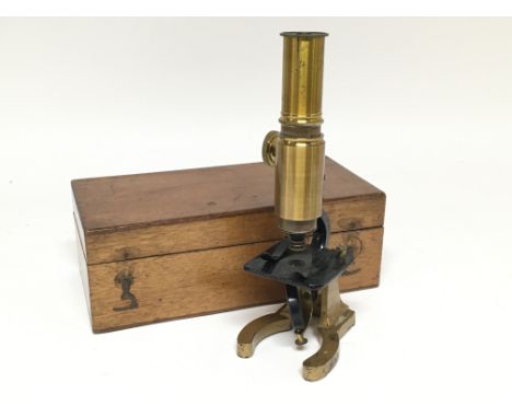 A brass student microscope in wooden fitted case