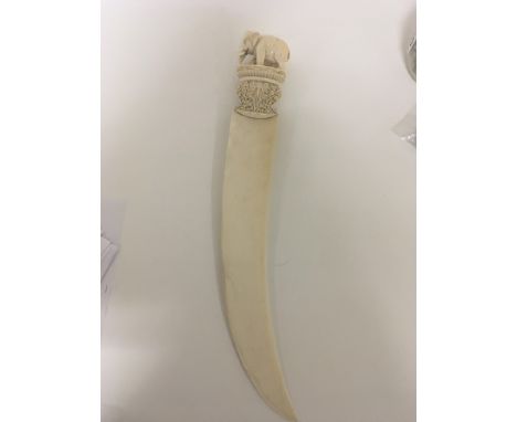 A large quality carved 19th century ivory paper knife the top surrounded with an elephant on an elaborate carved capital. Len