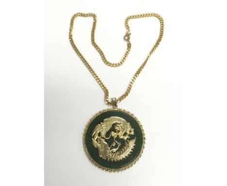 An Oriental jade pendant on a chain and decorated with the image of a dragon set with opals.