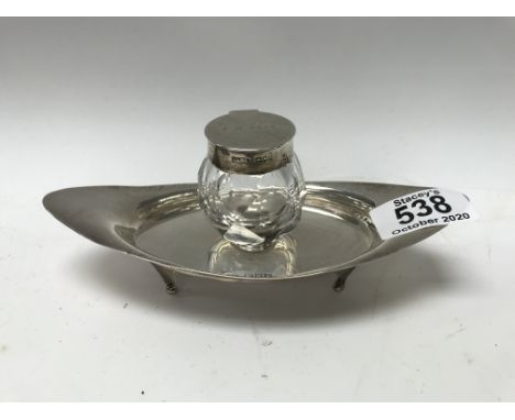 A small hallmarked silver inkwell and stand with marks for Charles &amp; George Asprey.
