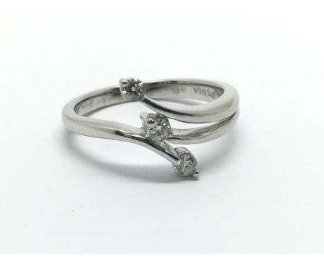 A 9ct white gold three stone diamond ring, approx .12ct, approx size K.