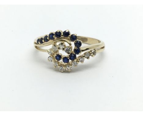 An 18ct gold sapphire and diamond swirl design ring, approx 3g and approx size N.