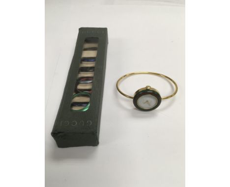 A Gucci bangle watch with changeable bezels.