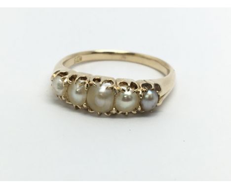 An 18ct gold ring set with five pearls, approx 3.5g and approx size N.