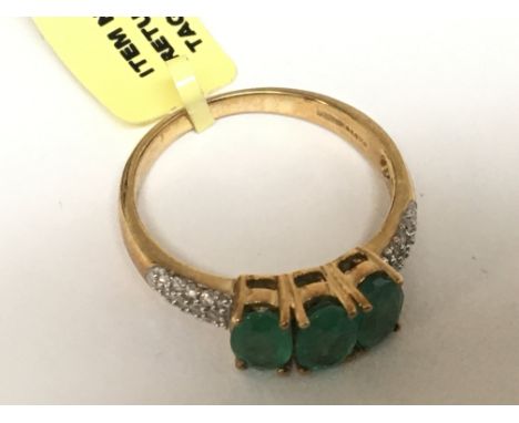 An 18carat gold ring set with three Emeralds with diamonds set into the shank ring size N-O
