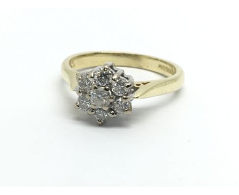 An 18ct gold seven stone diamond cluster ring in the form of a flowerhead, approx 1/2ct, approx 3.9g and approx size L- M.