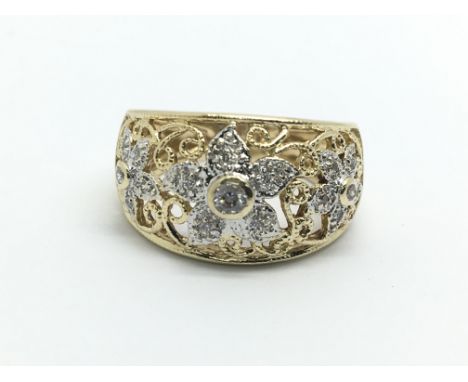 A 14ct gold diamond ring in the form of three flowerheads, approx 4g and approx size J-K.