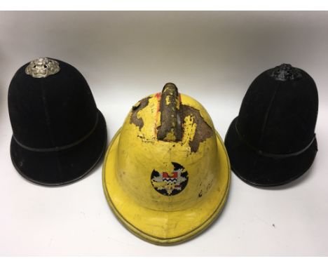 Vintage fireman’s helmet and two vintage police helmets