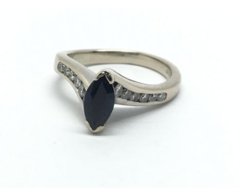 An 18ct white gold marquis shape sapphire and diamond ring, approx 4.6g and approx size J-K.
