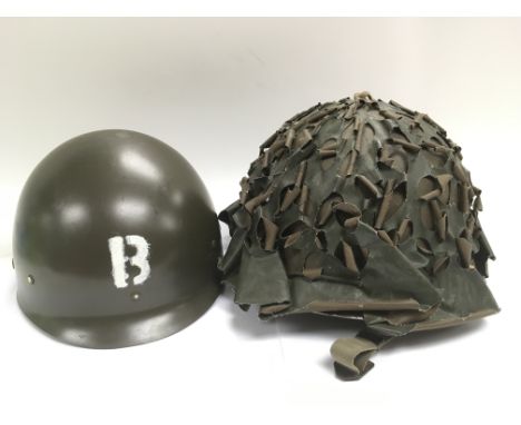 A vintage camouflage helmet stamped JAPY 1953 to the interior together with a reproduction example (2) - NO RESERVE