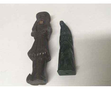 An unusual carved black stone carving and a carved wood continental nut cracker (2)