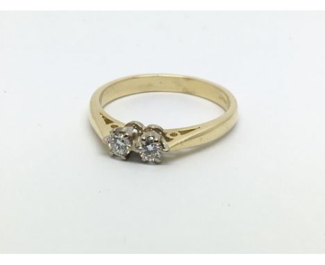 An 18ct gold two stone diamond ring, approx 1/4ct, approx 3.1g and approx size N.