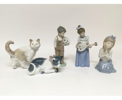 Five Nao figures including two cats, a boy with a football, and two girls