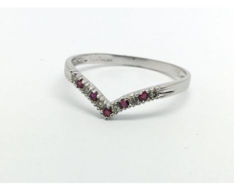 A 9ct gold wishbone ring set with rubies and diamonds, approx 0.8g and approx size O.