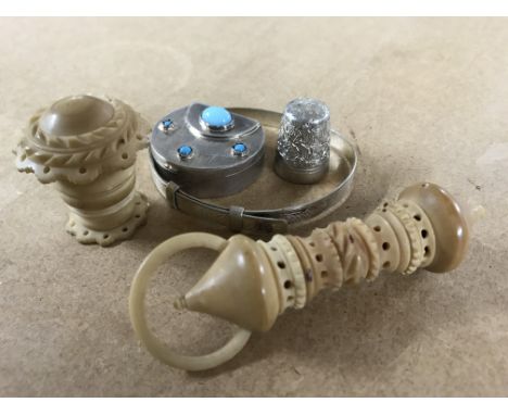 A white metal pill box, silver bangle, silver thimble and 2 coqilla nut sewing items.