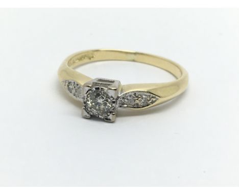 An 18ct gold solitaire diamond ring with further diamonds to the shoulders, approx 2.6g and approx size K-L.