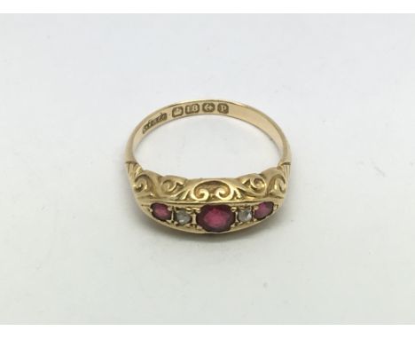 An 18ct gold five stone ruby and diamond ring, approx 2.8g and approx size O-P.